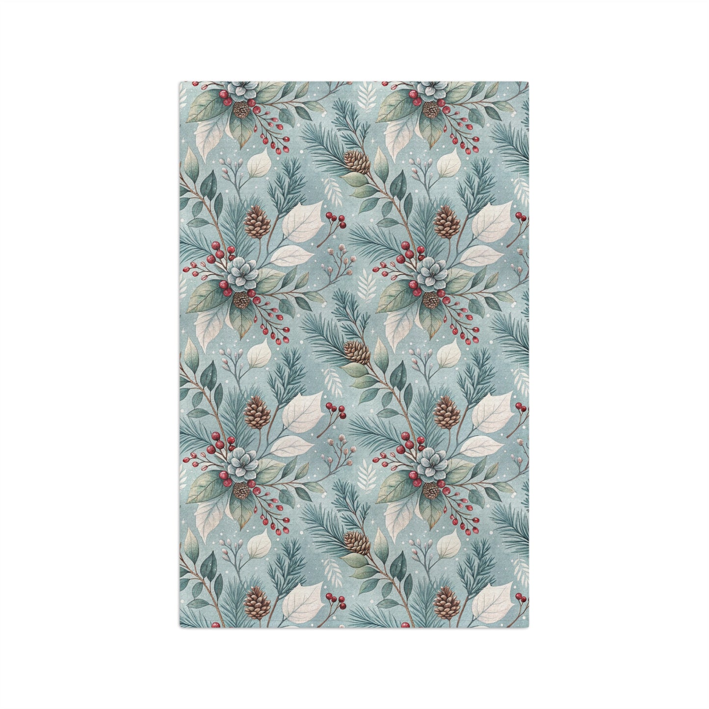 Microfiber tea towel with a repeating winter foliage pattern of teal sprigs, frosted leaves, pinecones, and red berries.