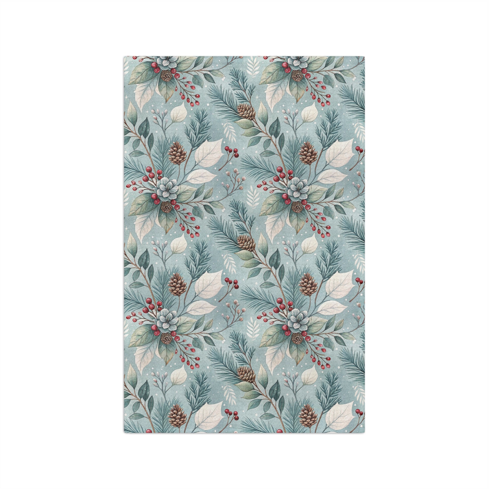 Microfiber tea towel with a repeating winter foliage pattern of teal sprigs, frosted leaves, pinecones, and red berries.