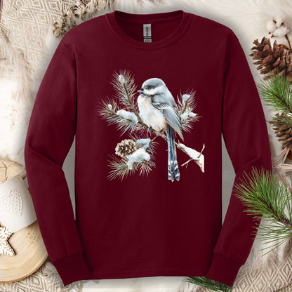 Maroon Gildan long sleeve tee with watercolor long-tailed tit on snowy evergreen branch.