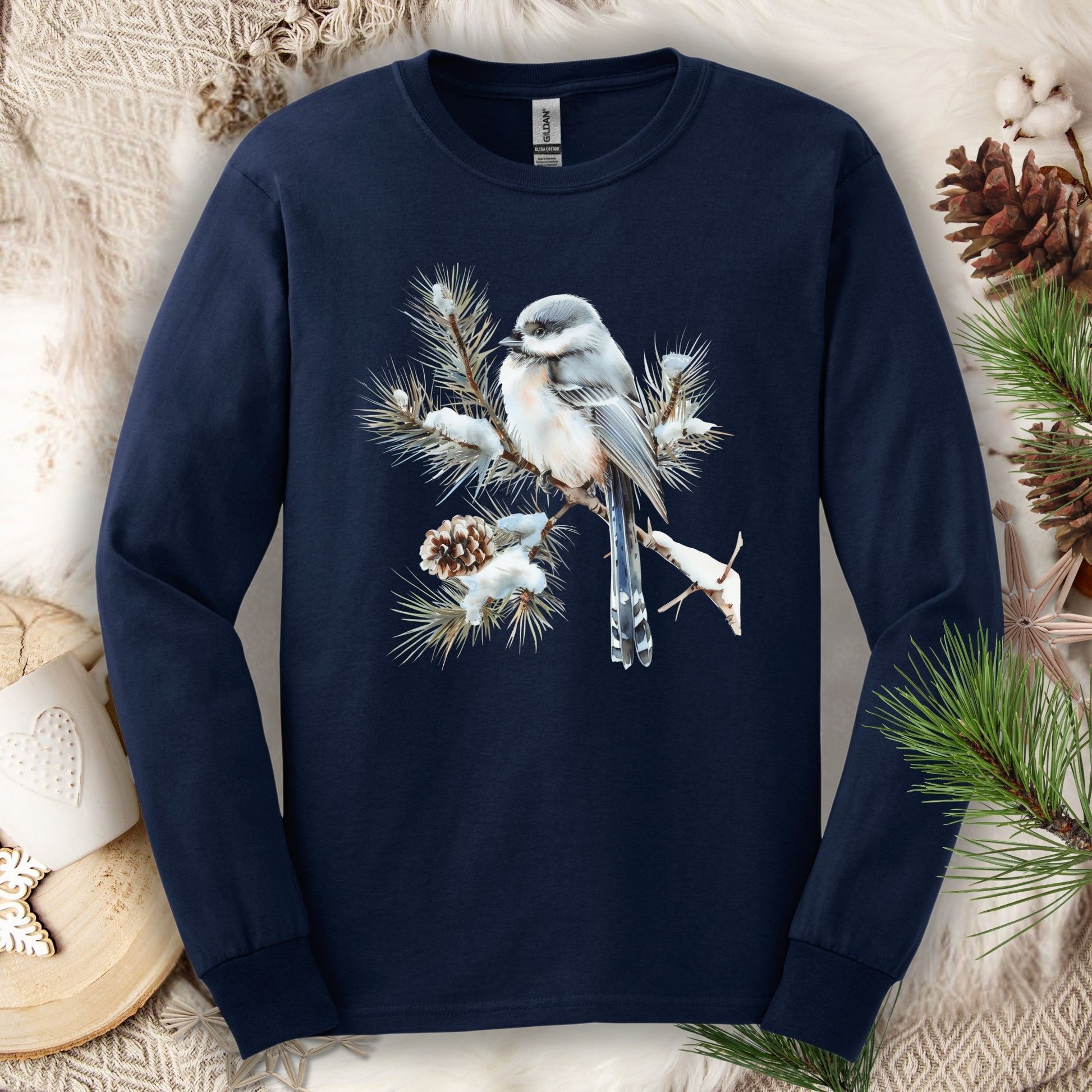 Navy long-sleeve tee with a watercolor long-tailed tit on a snowy evergreen branch.