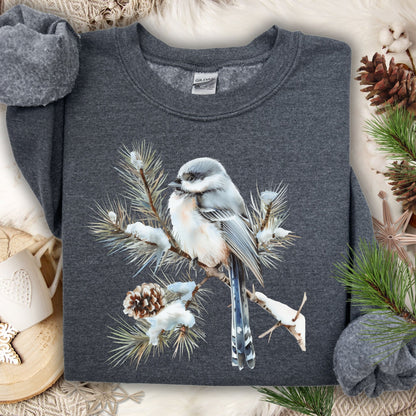 Dark gray Gildan sweatshirt with watercolor long-tailed tit on snowy evergreen branch.