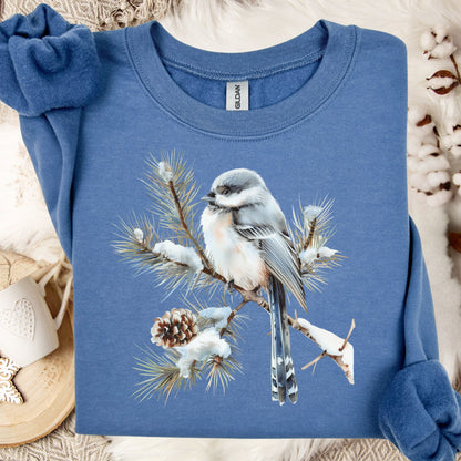 Indigo Blue S sweatshirt with a watercolor long-tailed tit on a snow-dusted evergreen branch.
