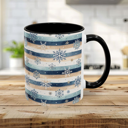 11oz ceramic mug with watercolor blue, beige, and white stripes, overlaid with delicate snowflakes, black interior and handle.