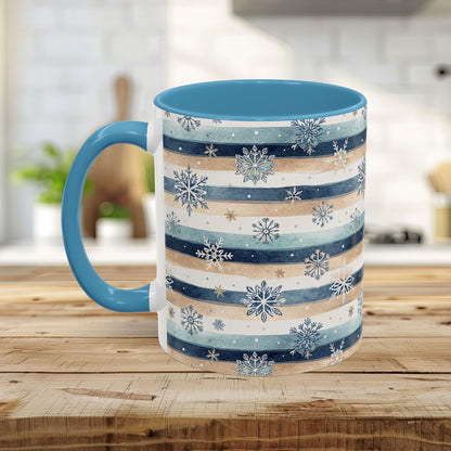 Ceramic mug with blue interior/handle, featuring watercolor blue, beige, and white stripes with snowflakes.