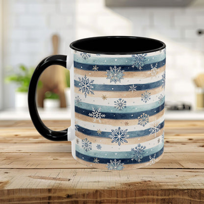 Ceramic mug with watercolor blue, beige, and white stripes, overlaid with delicate snowflakes. Black handle and interior.