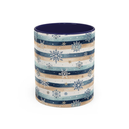 Ceramic mug with blue, beige, and white watercolor stripes, overlaid with delicate snowflakes, and a contrasting dark blue interior.