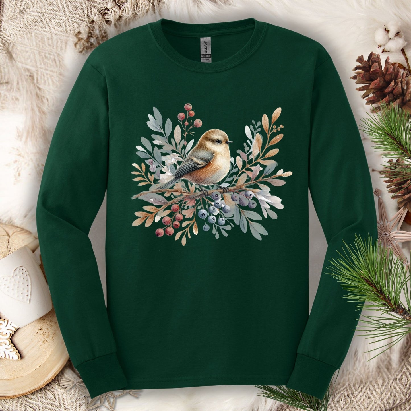 Forest green long sleeve tee with a boho sparrow on snowy branches and winter berries.