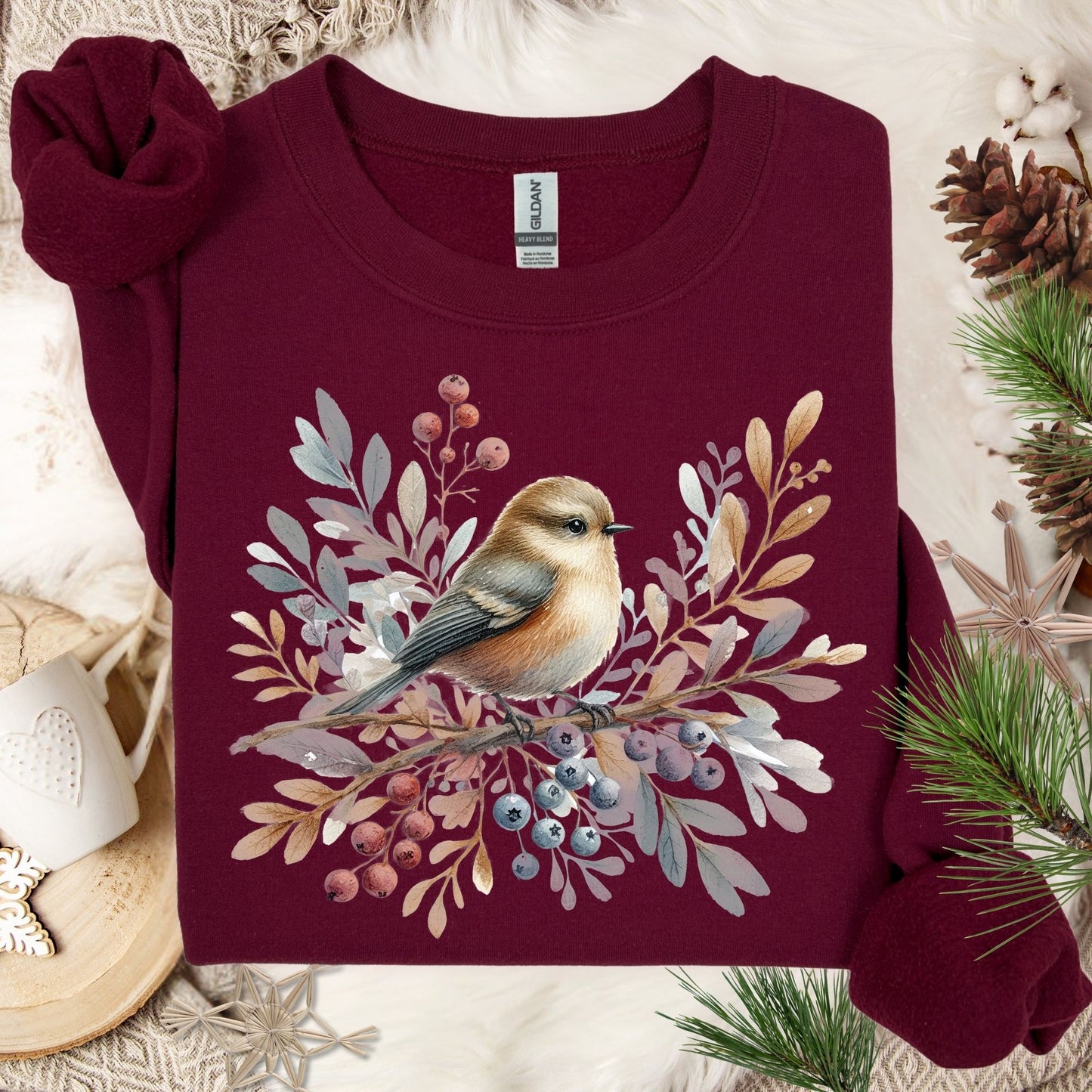 Maroon Gildan crewneck sweatshirt with a watercolor winter sparrow, berries, and foliage design.