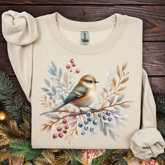 Sand Gildan crewneck sweatshirt with a watercolor winter sparrow, berries, and foliage design.