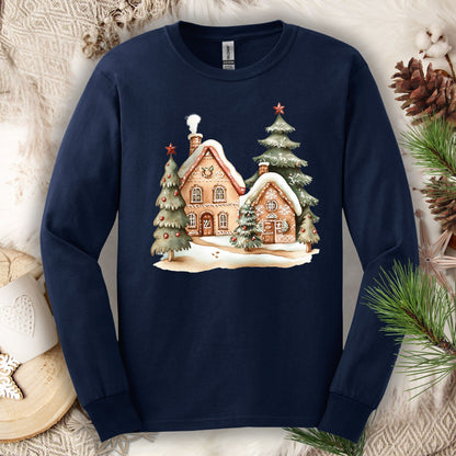 Navy long sleeve tee with a watercolor gingerbread house and snowy evergreen design.