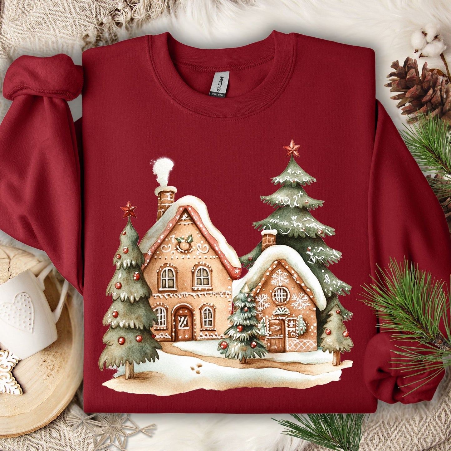 Cardinal Red Gildan 18000 sweatshirt with a gingerbread village and Christmas trees design.