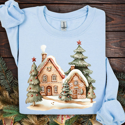 Light blue Gildan sweatshirt with a whimsical gingerbread village and Christmas trees design.