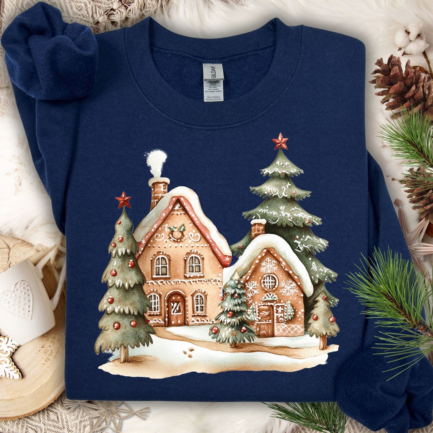 Navy Gildan 18000 sweatshirt with a gingerbread village and Christmas trees design.
