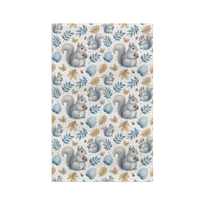 Microfiber tea towel with watercolor squirrels and autumn leaves in blues and ochres.