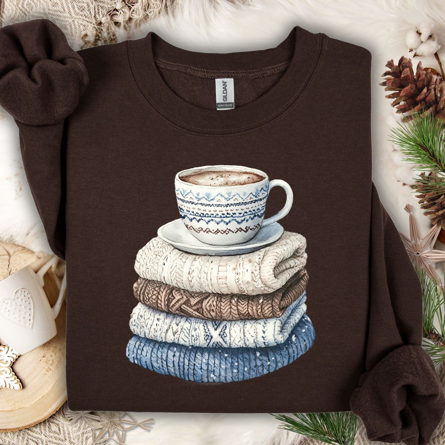 Dark Chocolate S sweatshirt with a watercolor-style print of stacked knit sweaters and a patterned coffee mug.
