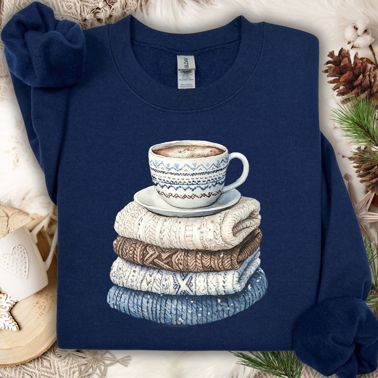 Navy S Winter Wool Sweaters and Coffee Sweatshirt with a watercolor stack of knitwear and a patterned mug.