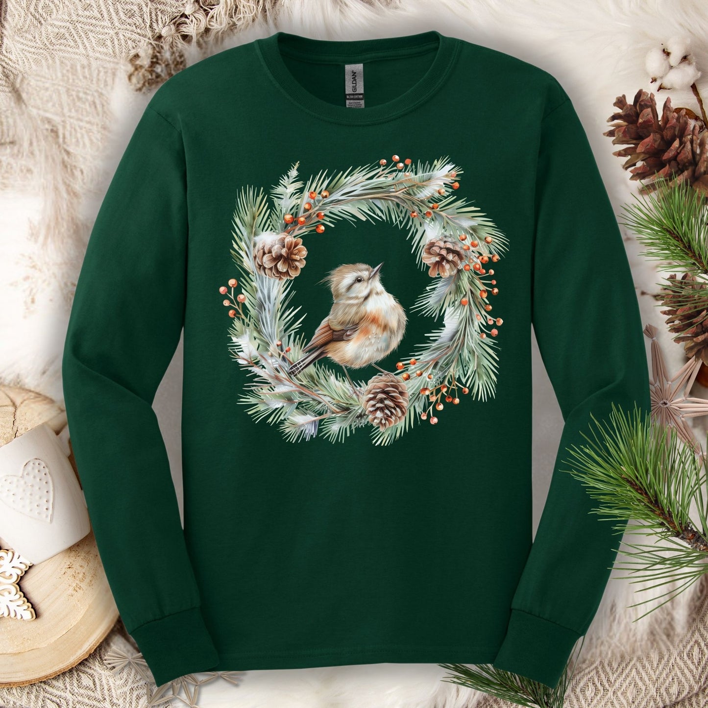 Forest Green long sleeve tee with a watercolor winter wren in an evergreen and pinecone wreath design.