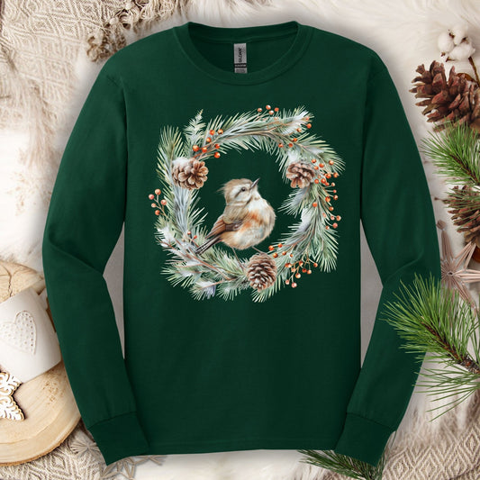 Forest Green long sleeve tee with a watercolor winter wren in an evergreen and pinecone wreath design.