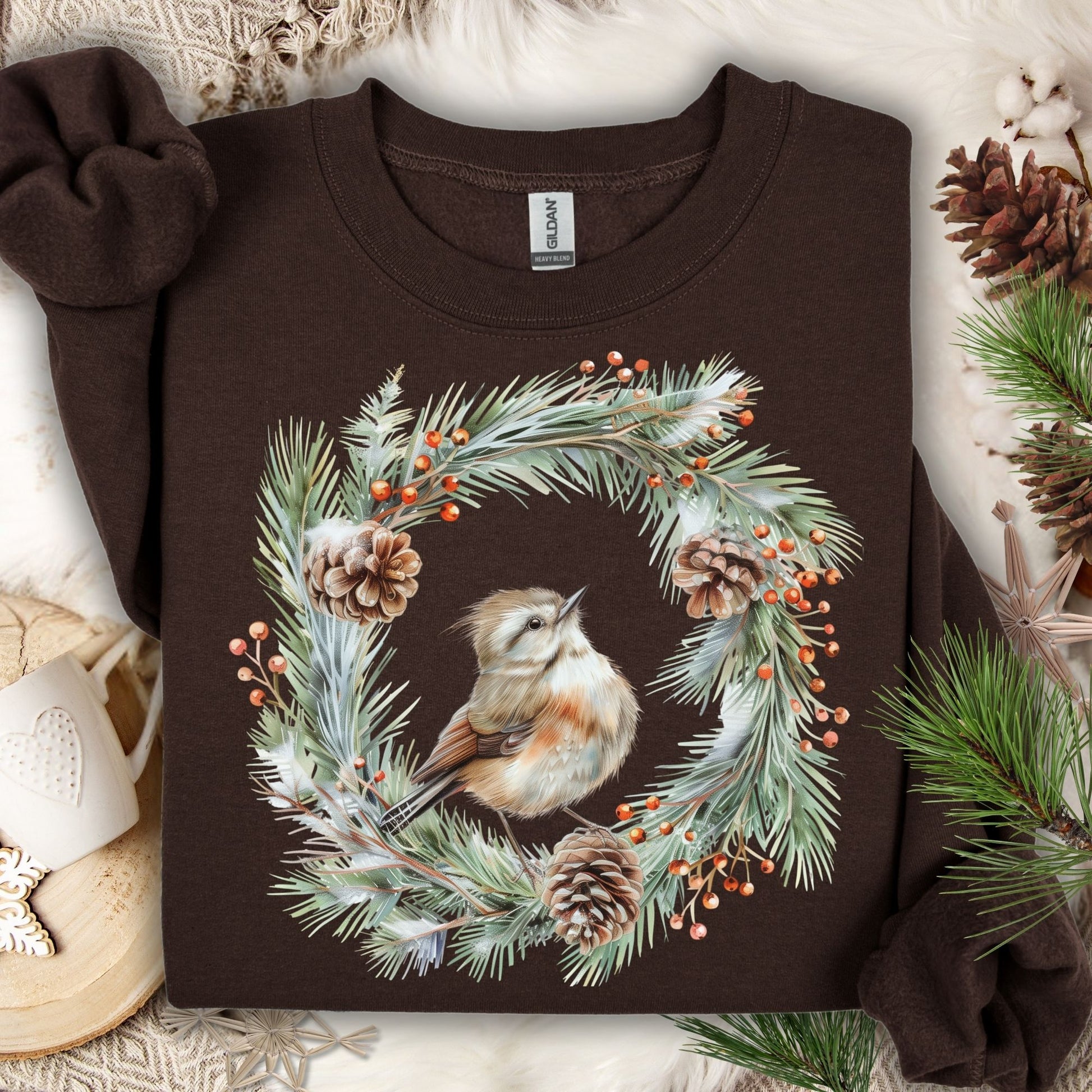 Dark brown sweatshirt with watercolor wren in evergreen wreath, pinecones, and red berries.