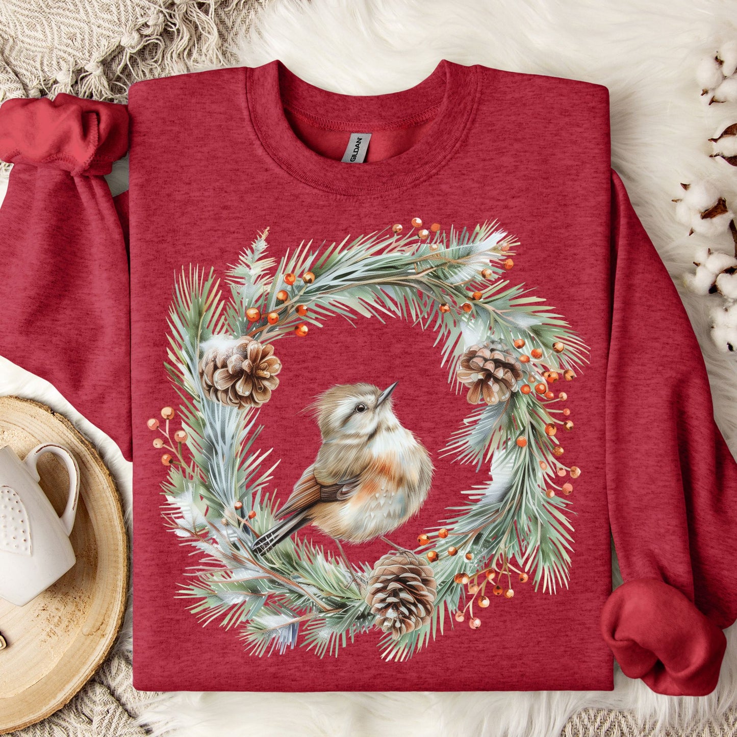 Antique Cherry Red sweatshirt with watercolor wren in evergreen wreath, pinecones, and berries.