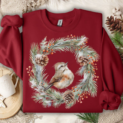 Cardinal Red sweatshirt with watercolor wren in evergreen wreath, pinecones, and berries.