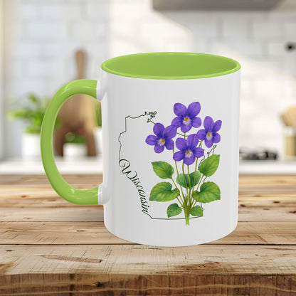 White ceramic mug with green handle and interior, featuring watercolor wood violets and a Wisconsin outline.