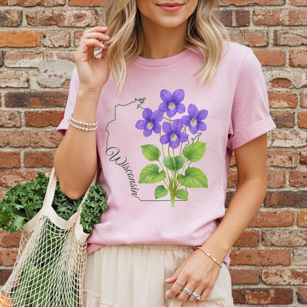 Garment-dyed pink t-shirt with a watercolor wood violet design and Wisconsin state outline.