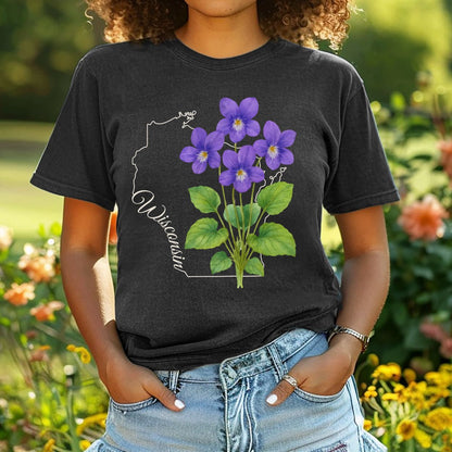 Garment-dyed black t-shirt with a watercolor wood violet cluster over a subtle Wisconsin outline.