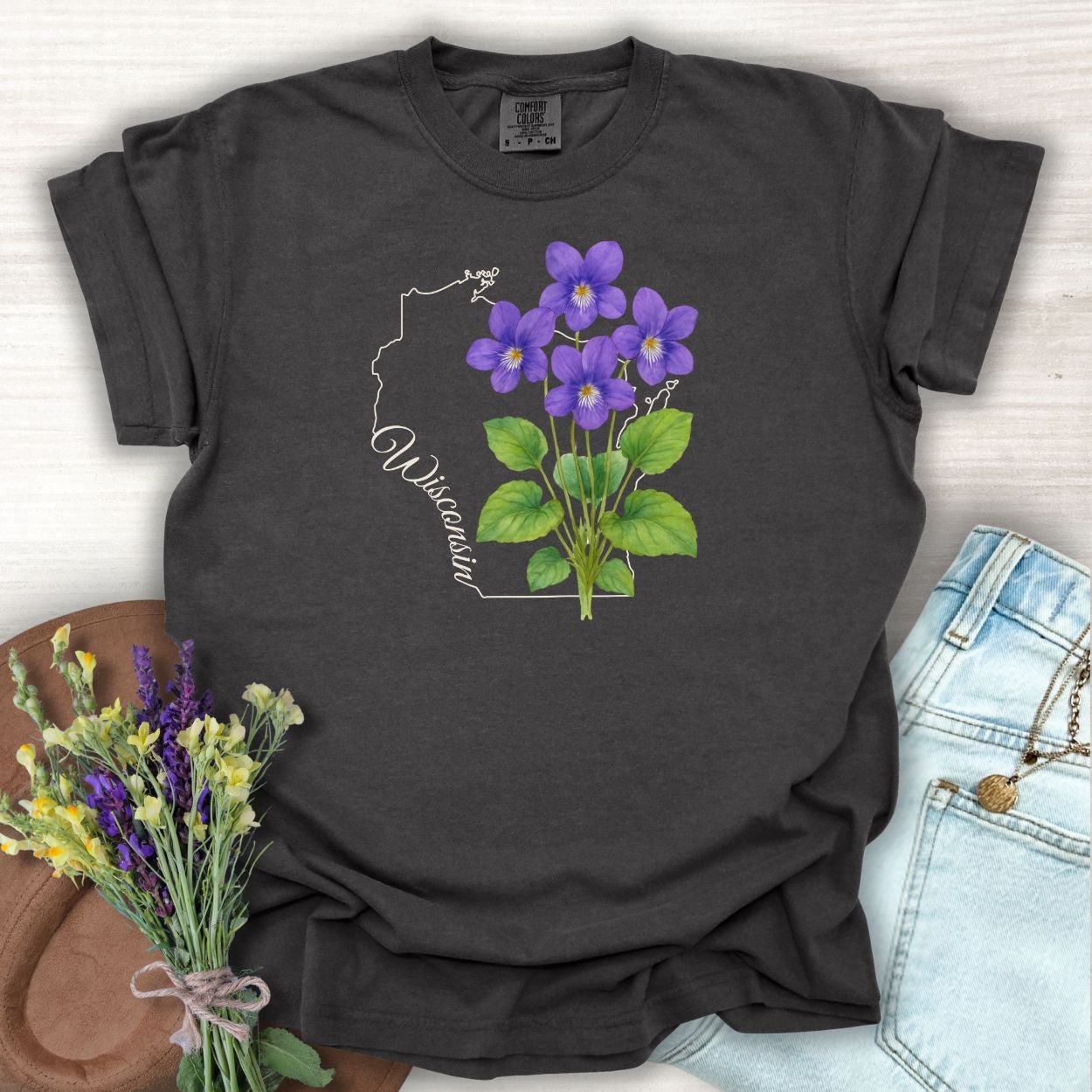 Pepper S-size garment-dyed cotton t-shirt with a watercolor wood violet design and Wisconsin outline.