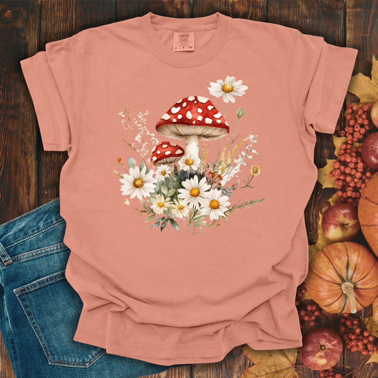 Terracotta garment-dyed t-shirt with a vintage red mushroom and daisy floral illustration.
