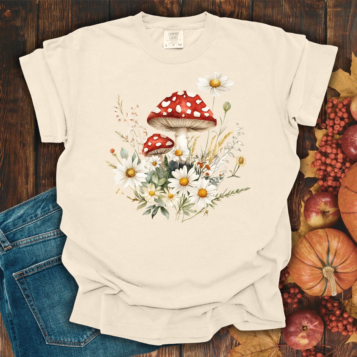 Ivory relaxed-fit t-shirt with a vintage-inspired red mushroom, daisy, and meadow floral illustration.