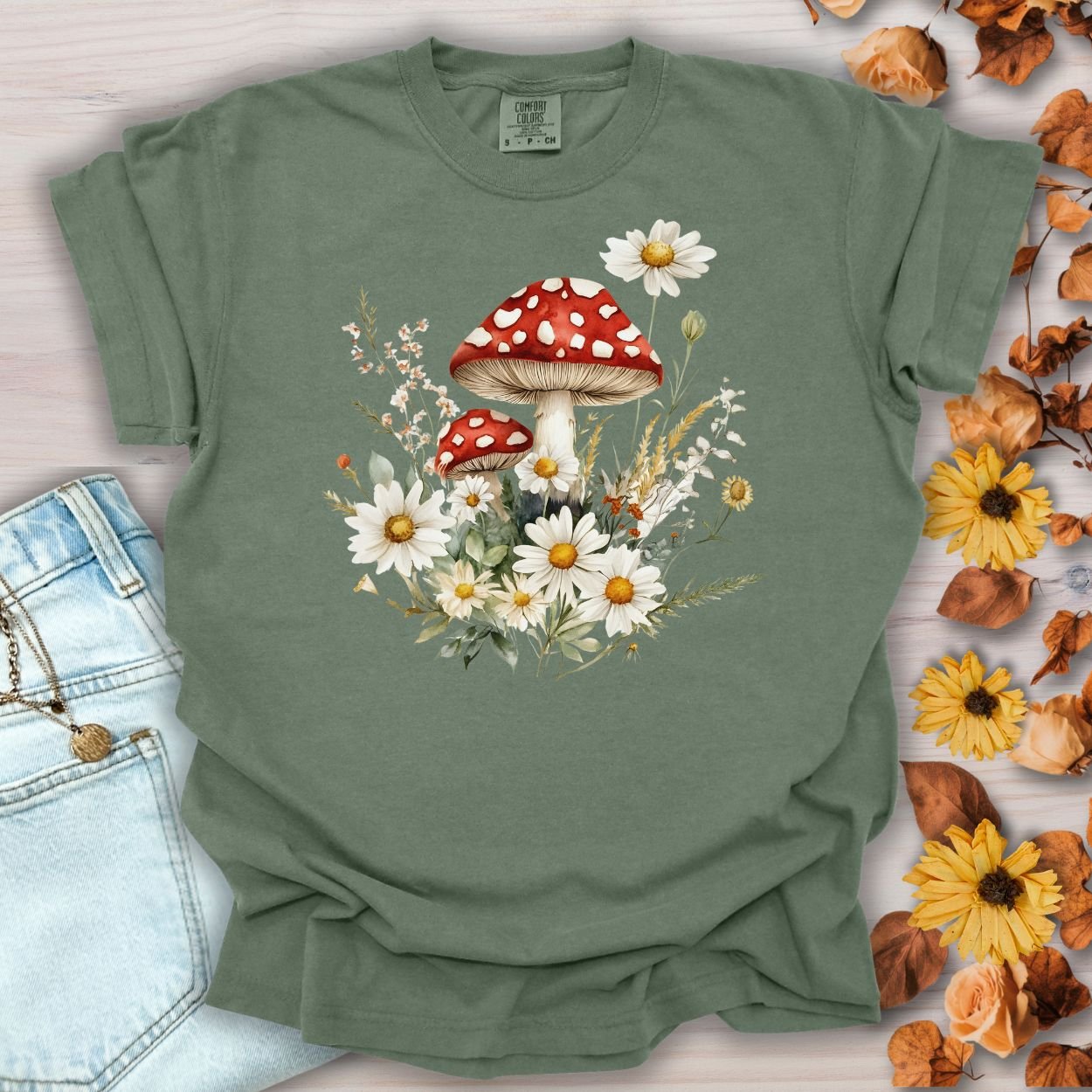 Moss green relaxed-fit t-shirt with a vintage woodland floral mushroom and daisy illustration.