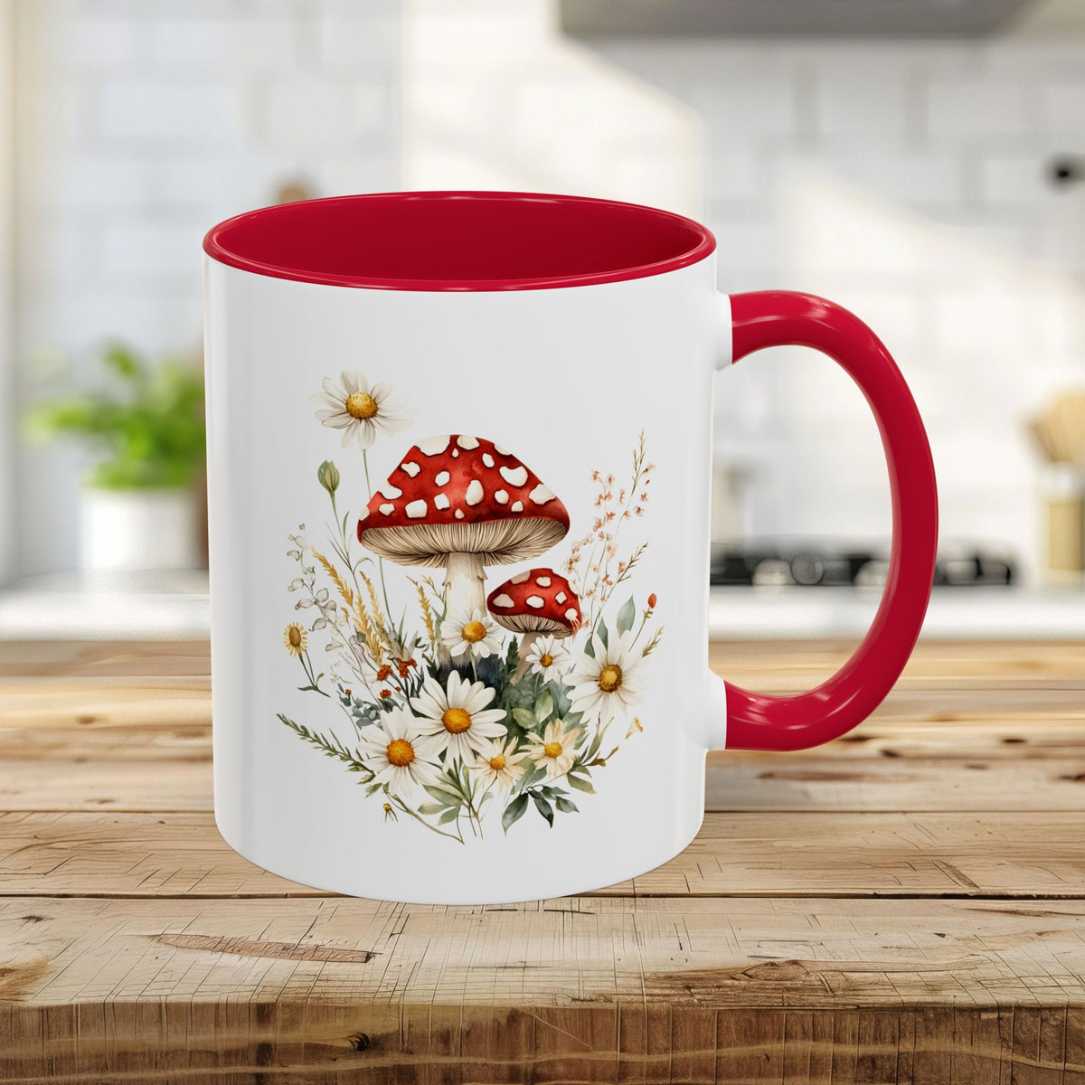 11oz ceramic mug with red interior/handle, featuring a vibrant watercolor print of red-capped mushrooms and daisies.