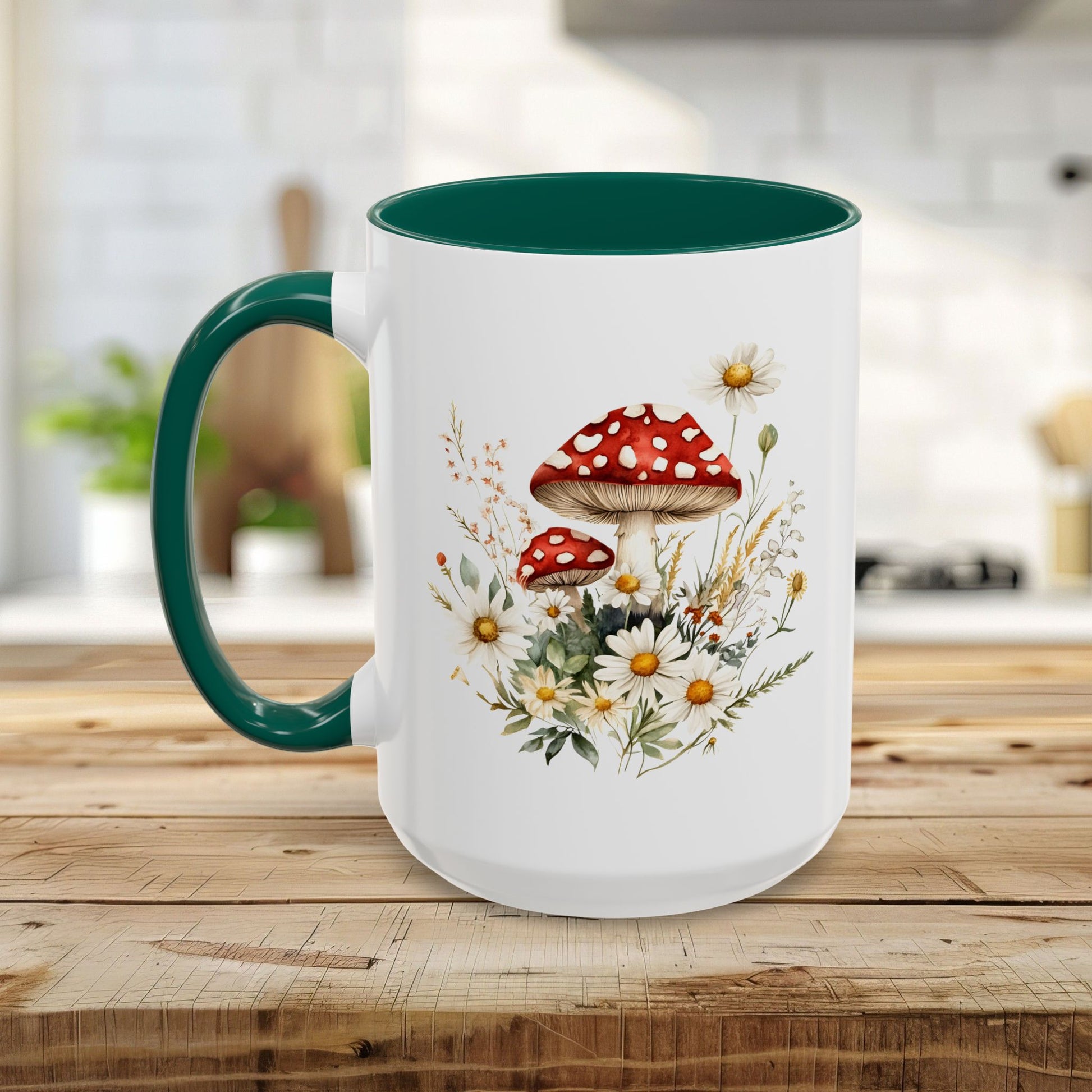White ceramic mug with green handle and interior, featuring a watercolor print of red-capped mushrooms and daisies.