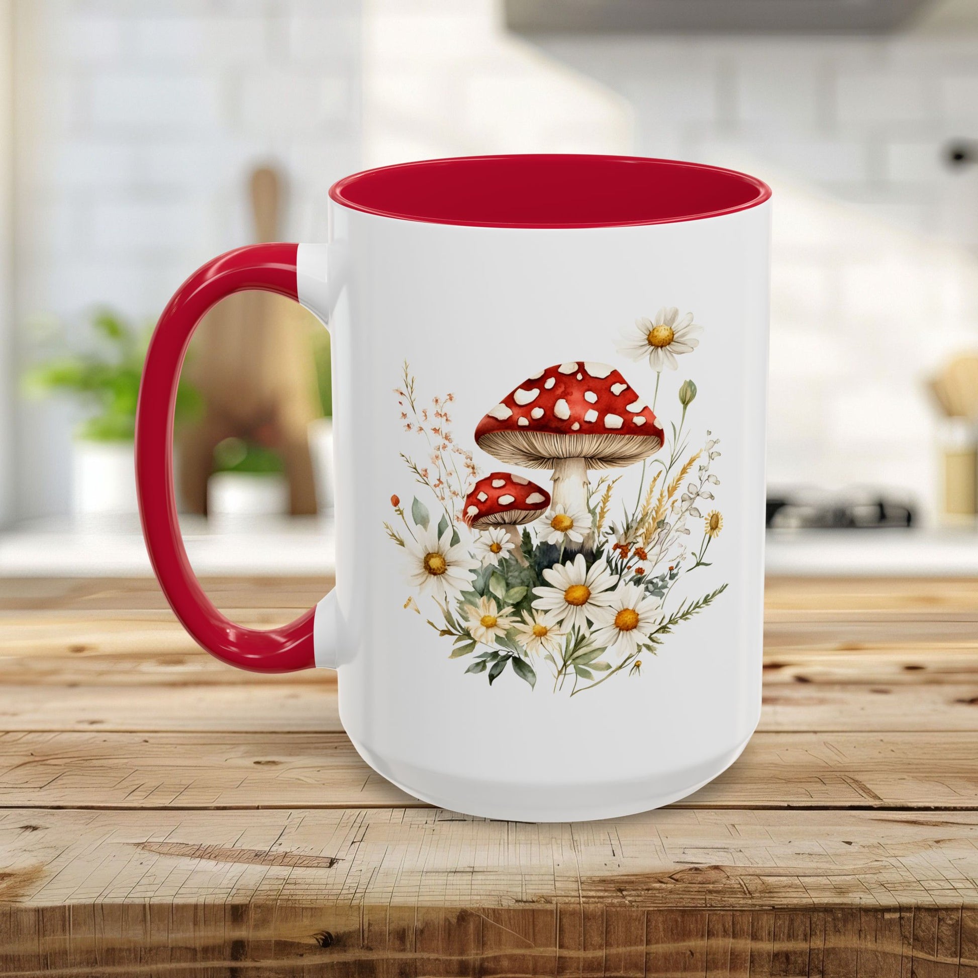 White ceramic mug with red interior and handle, featuring a watercolor print of red-capped mushrooms and daisies.