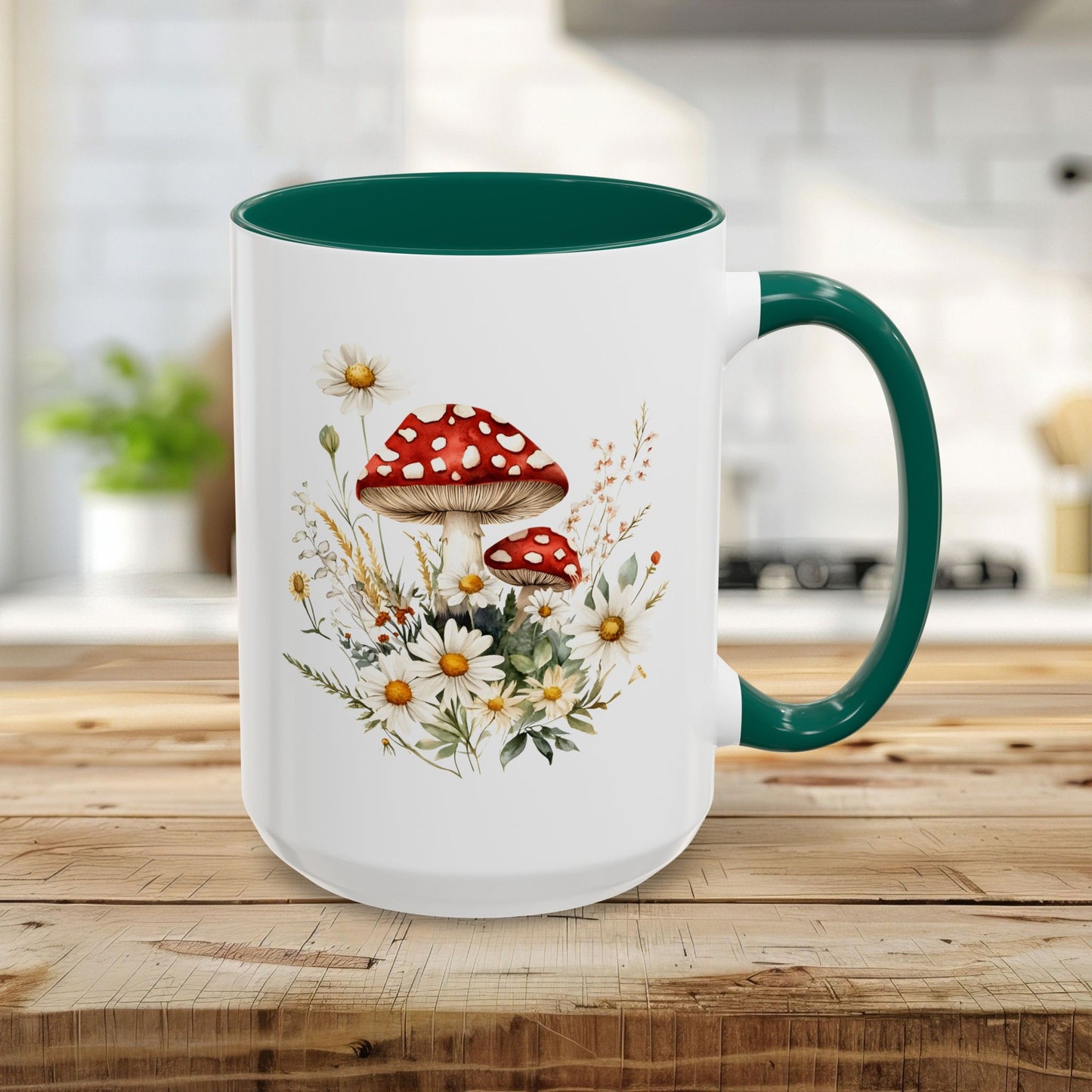 15oz ceramic mug with a green interior/handle and a watercolor print of red mushrooms, daisies, and wild grasses.