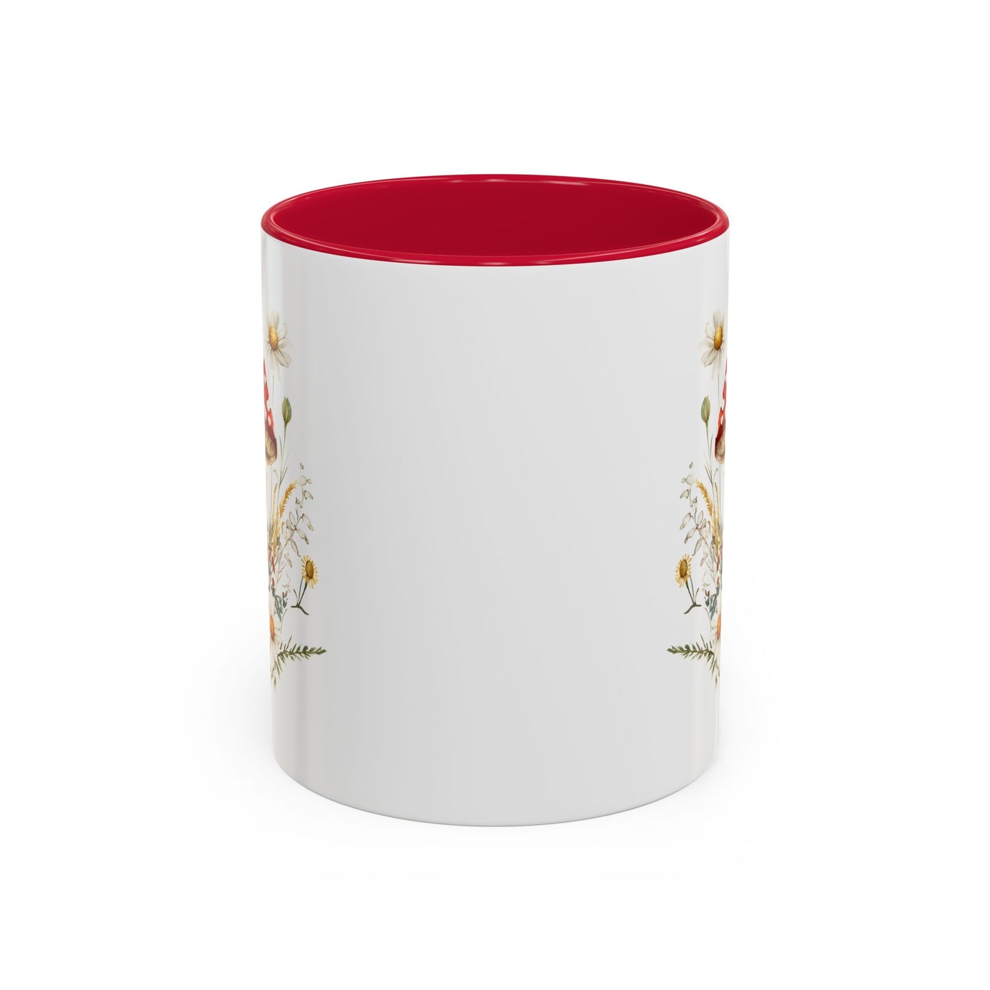 White ceramic mug with a red interior and handle, featuring a watercolor print of red-capped mushrooms, daisies, and wild grasses.