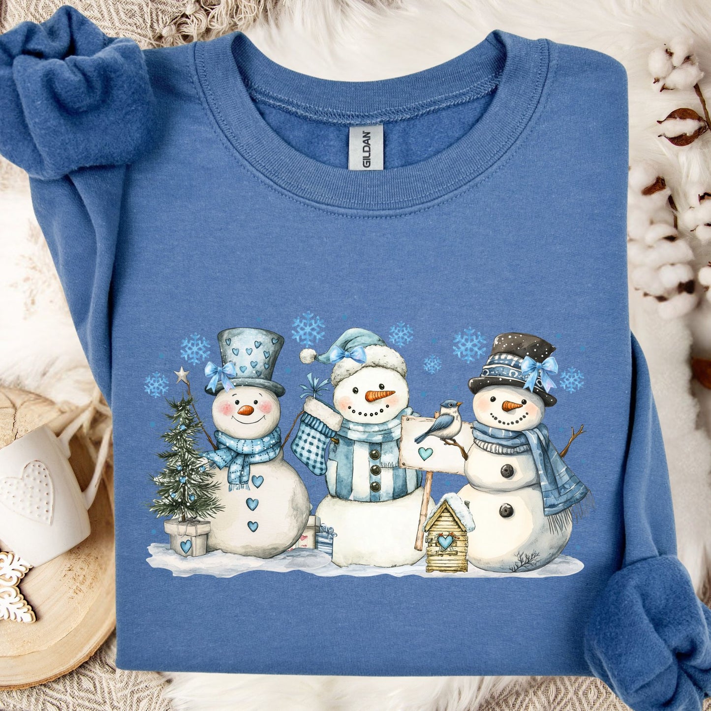 Indigo Blue S sweatshirt with watercolor snowmen, blue hats, scarves, birdhouse, and snowflakes.