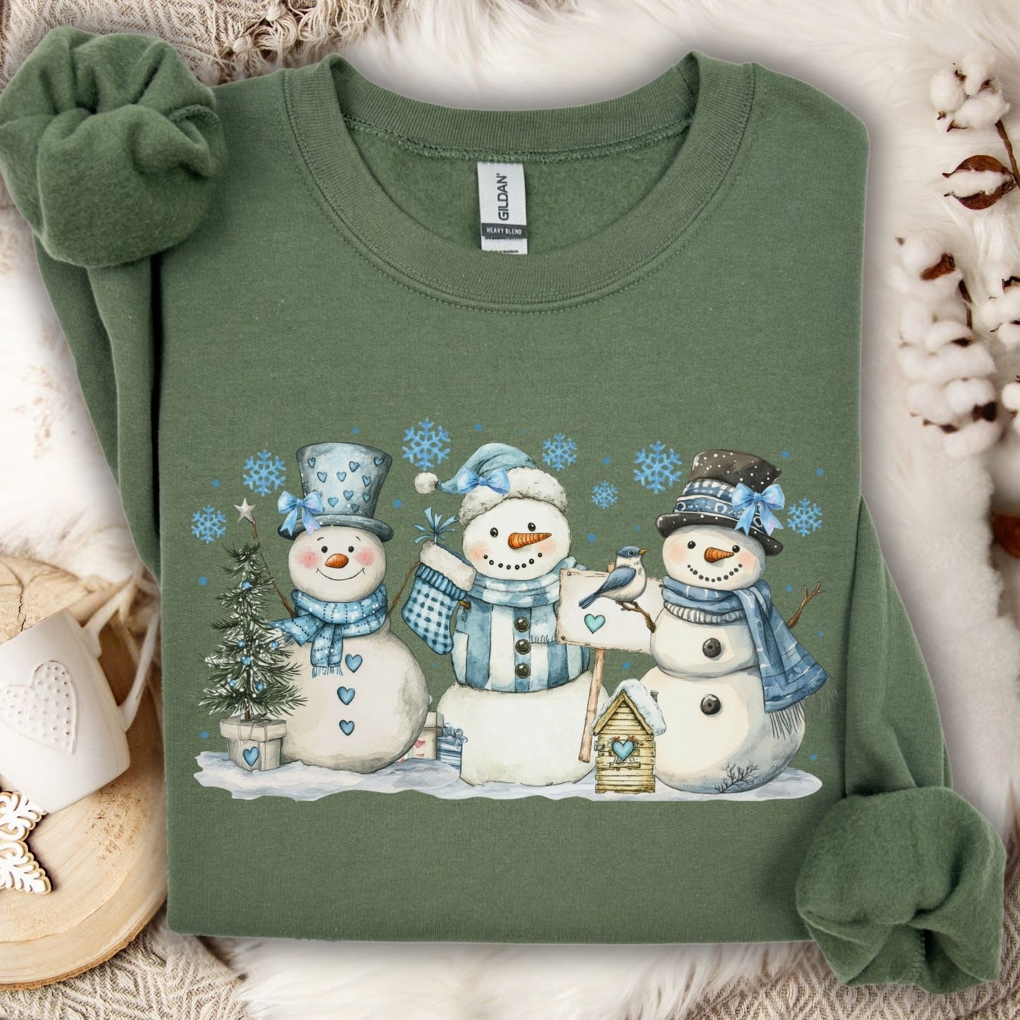 Military Green S sweatshirt with watercolor snowmen, blue hats/scarves, birdhouse, and snowflakes.