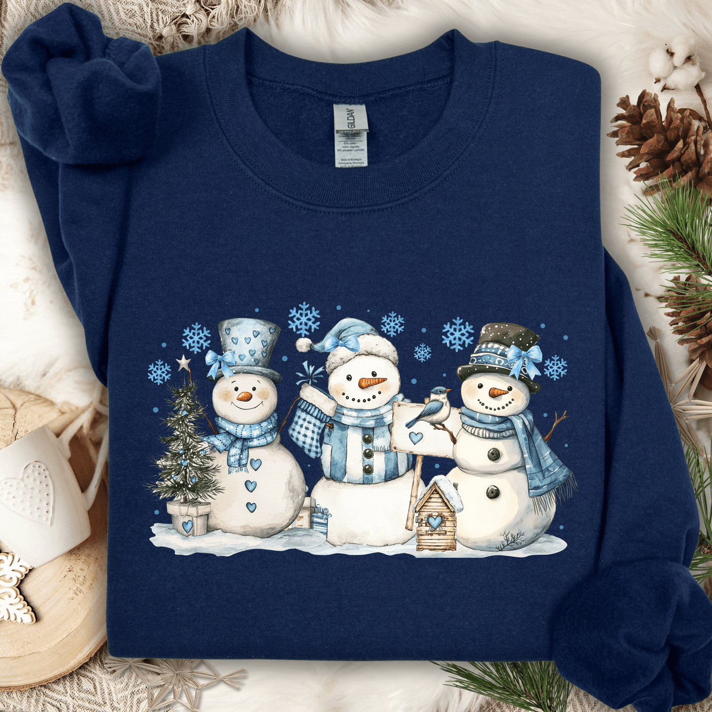 Navy S sweatshirt with watercolor woodland snowmen, blue hats/scarves, birdhouse, and birds.