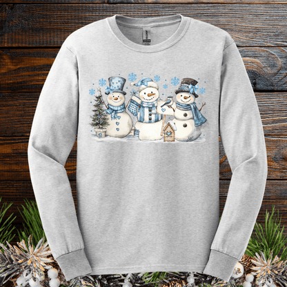 Light gray long sleeve tee with watercolor woodland snowmen, blue hats, scarves, and snowflakes.