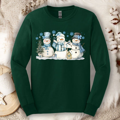 Forest Green long sleeve tee with three watercolor snowmen, blue hats, scarves, and snowflakes.