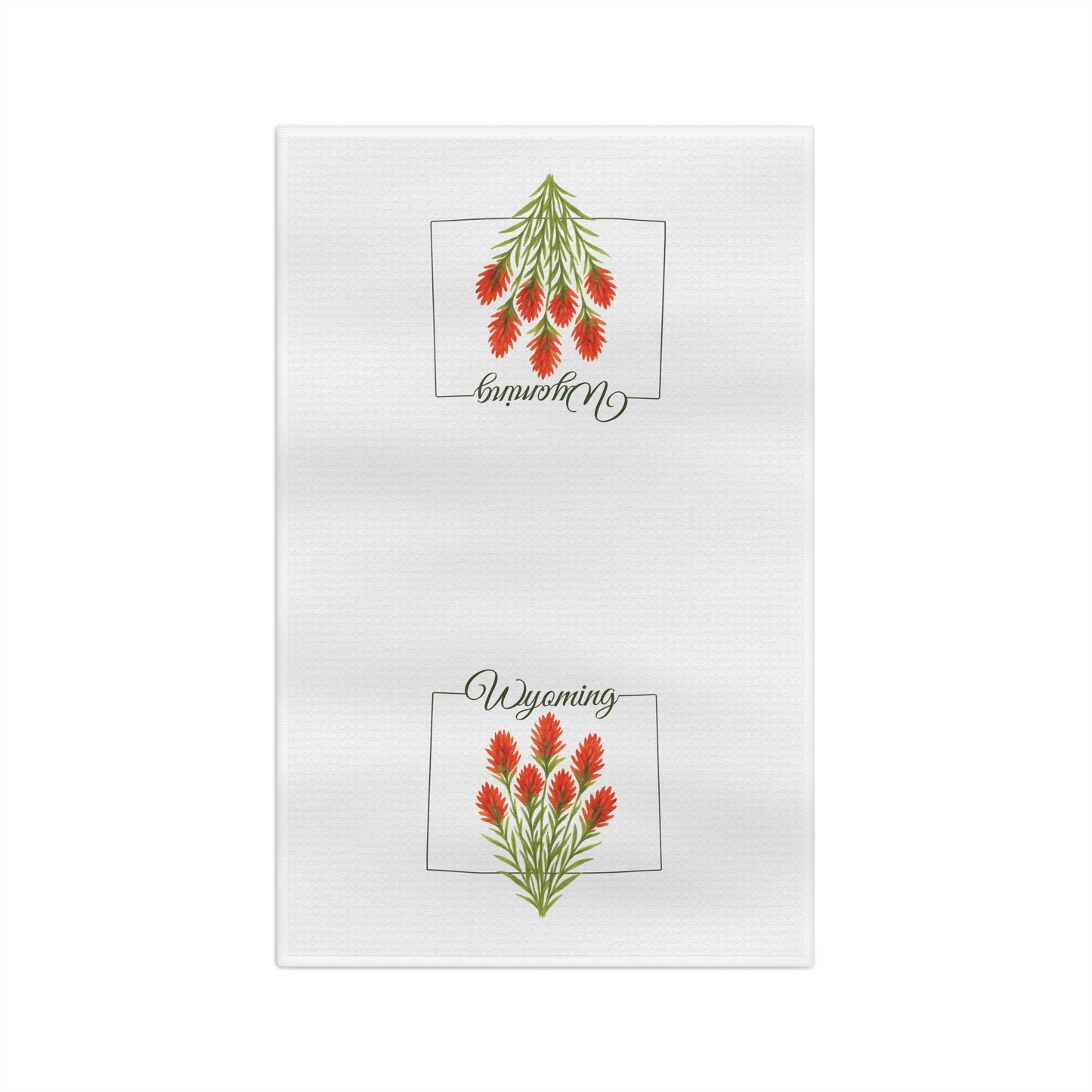 White microfiber tea towel with two red Indian Paintbrush flower designs and "Wyoming" script.