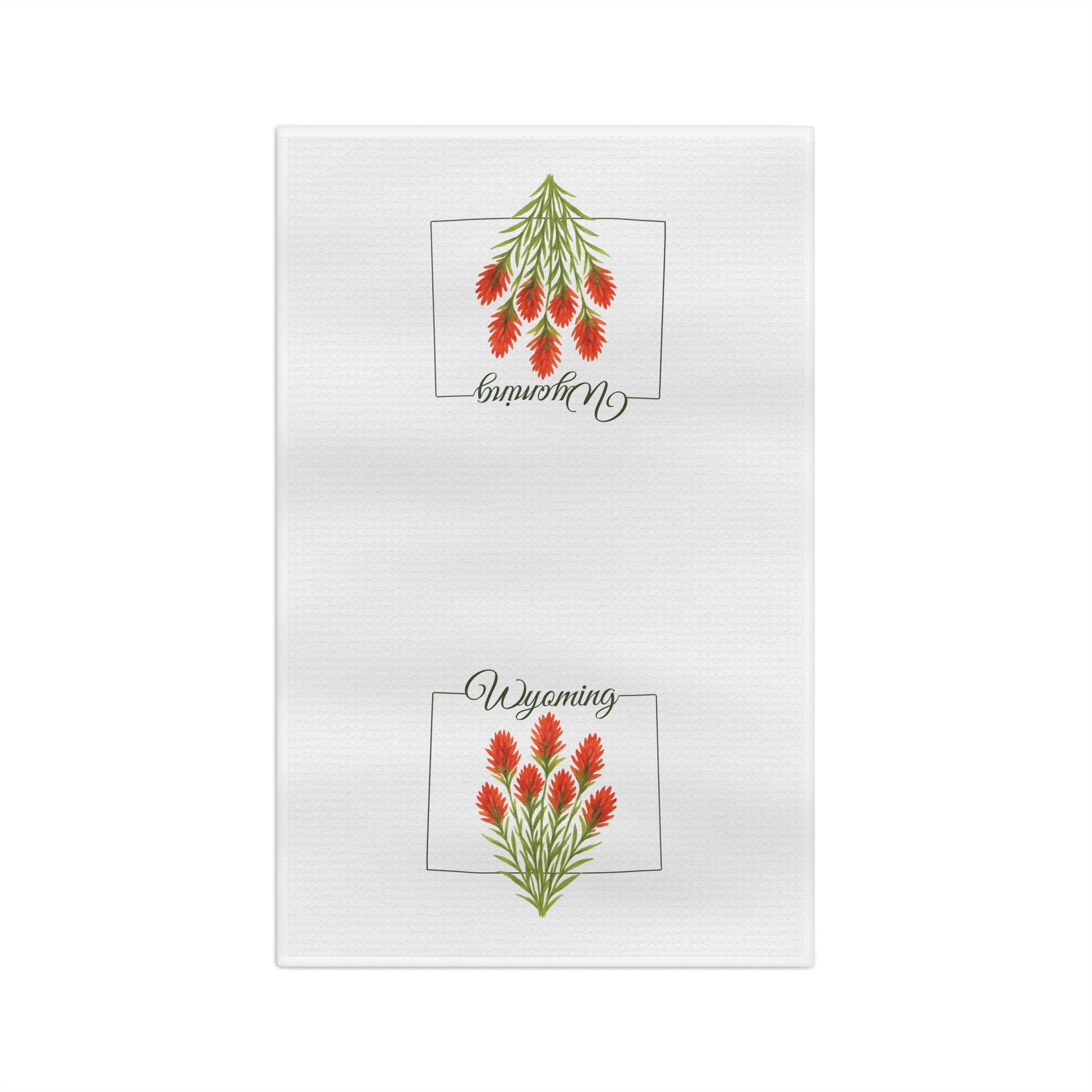 White microfiber tea towel with two red Indian Paintbrush flower designs and "Wyoming" script.