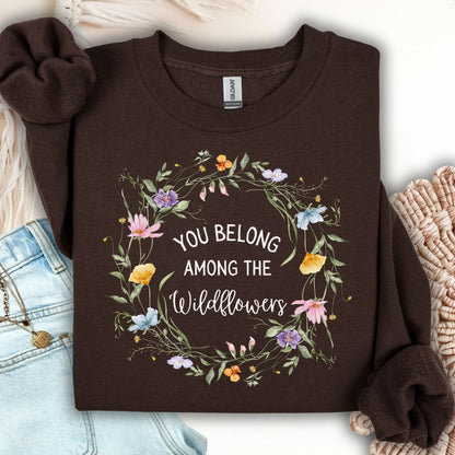 Dark chocolate Gildan sweatshirt with a watercolor wildflower wreath and "You belong among the wildflowers" text.