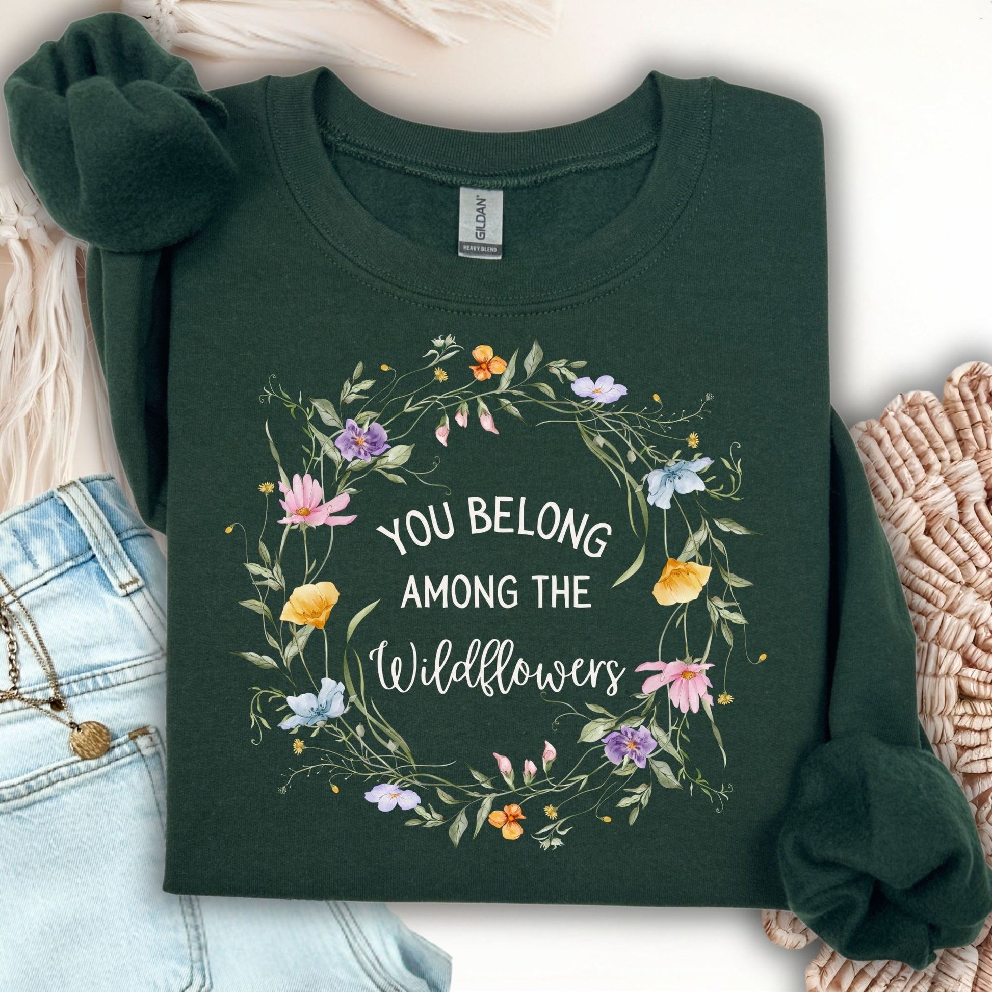 Forest Green Gildan sweatshirt with "You belong among the wildflowers" in a watercolor floral wreath.