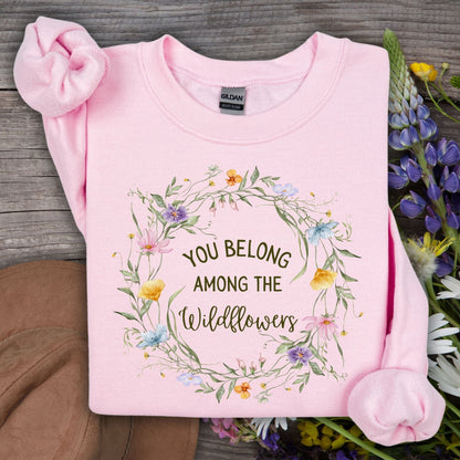 Light pink Gildan crewneck sweatshirt with "You belong among the wildflowers" in a watercolor wreath.