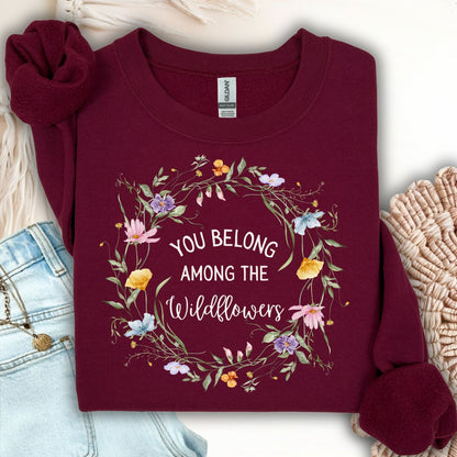 Maroon Gildan sweatshirt with "You belong among the wildflowers" in a watercolor floral wreath.